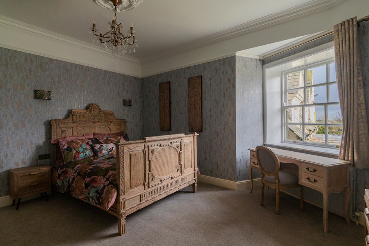 Double bedroom with ornate bed and desk